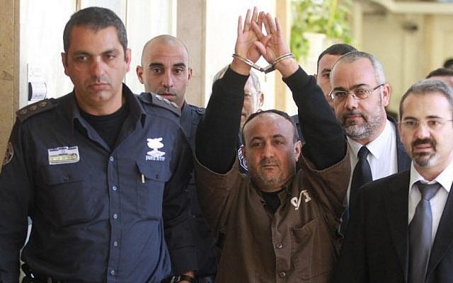 Fatah terror chief Marwan Barghouti, serving five life terms for murder during the Second Intifada, is escorted by Israeli police into Jerusalem's Magistrate Court to testify as part of a US civil lawsuit against the Palestinian leadership, in January 2012. (Flash90)