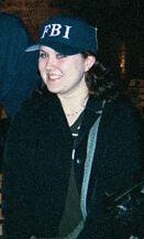 Teenaged Kathryn wearing an FBI baseball cap and a black "Agent Scully" trench coat