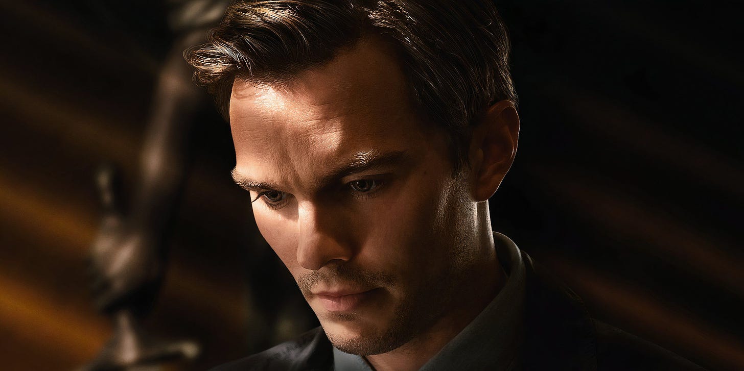 Nicholas Hoult in big close-up looks down and broods in moody lighting in Clint Eastwood's 2024 film Juror #2