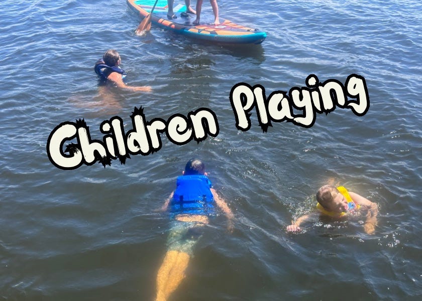 Three children are playing in the water, wearing life jackets, with one child on a paddleboard. The words "Children Playing" are overlaid on the image in playful, bold text.