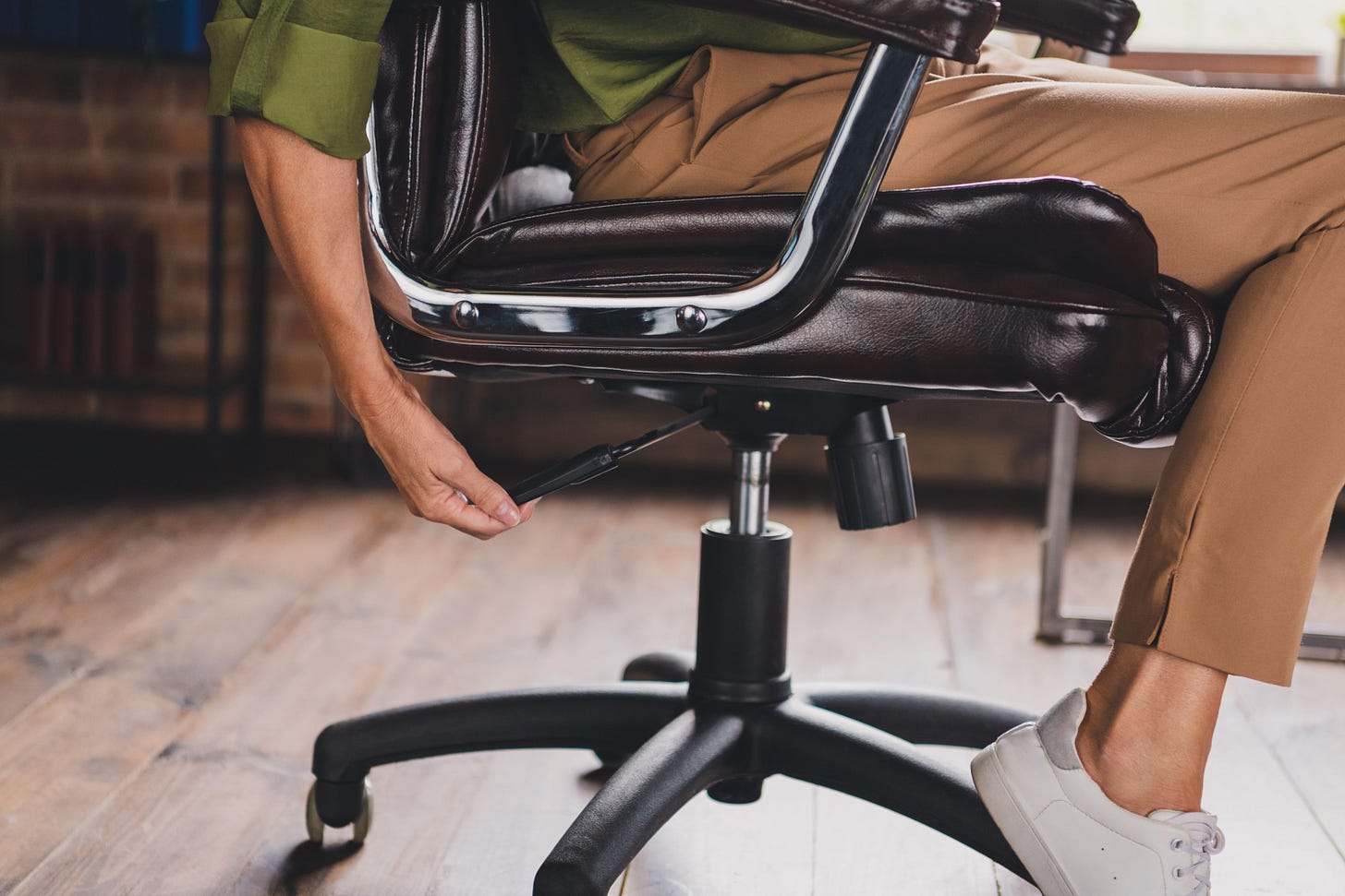 Woman adjusting the height of her office chair 