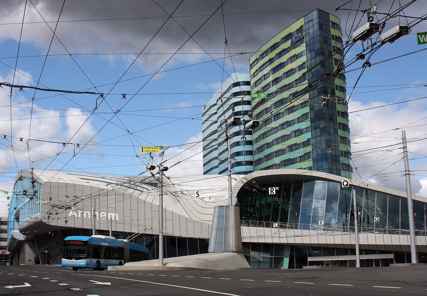 A beatiful modern train station and a trolleybus