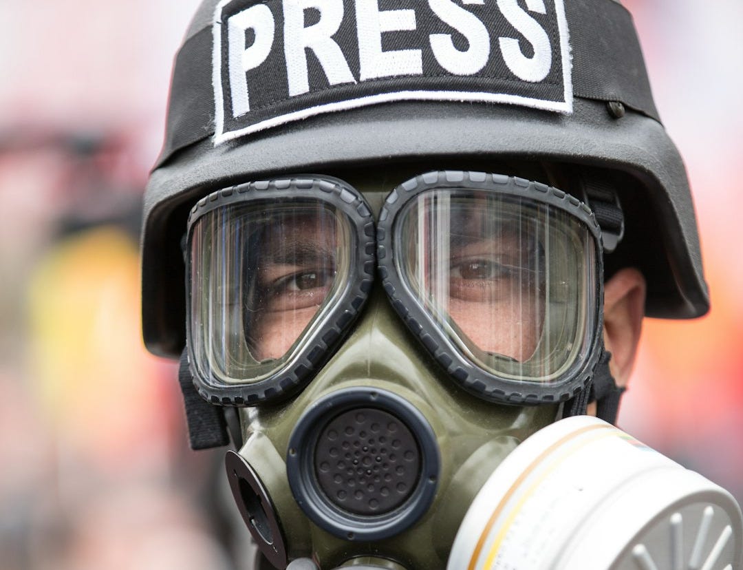 person wearing black and white gas mask