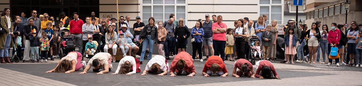 A group of people doing push ups

Description automatically generated with low confidence