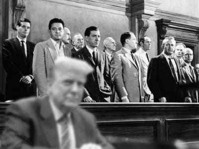 Donald Trump seated in front of the jury from the movie 12 Angry Men