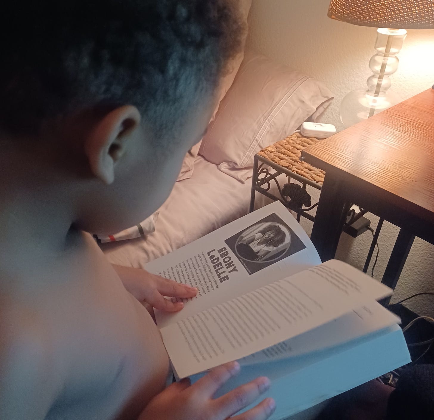 Image of young child reading Love Radio by Ebony Ladelle