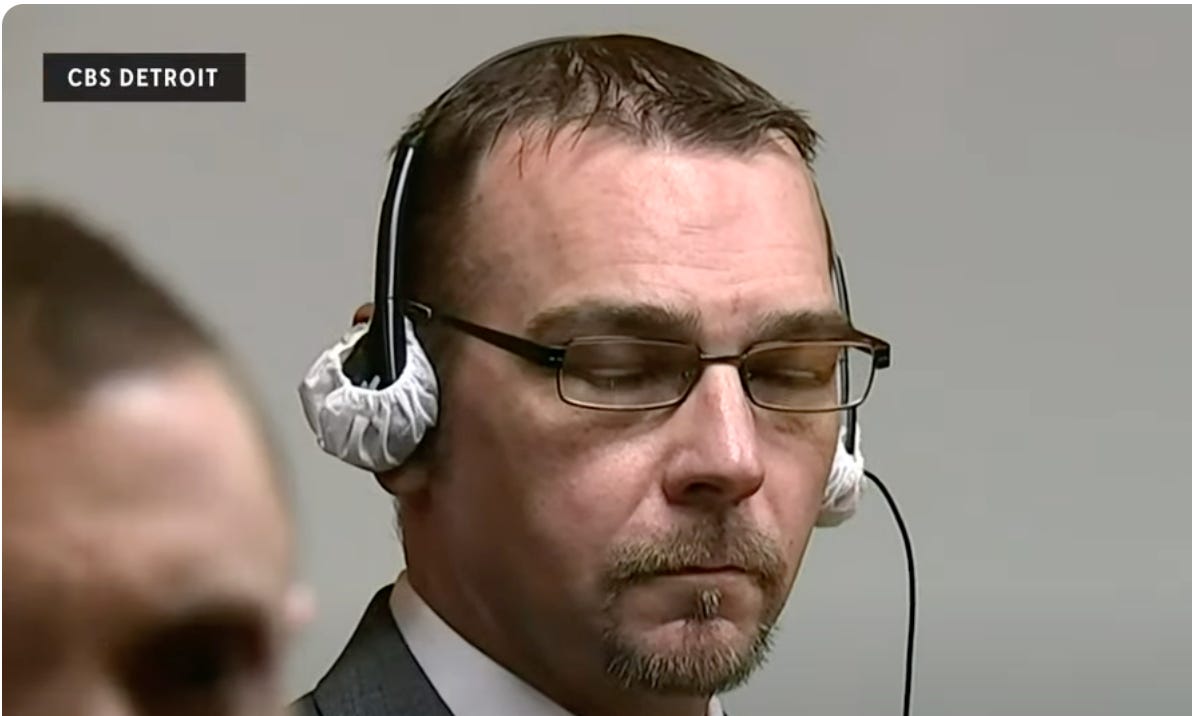 James Crumbley, a white man with brown hair and classes, closing his eyes and waiting on the verdict, while wearing some kind of newfangled headphones that look like shower caps