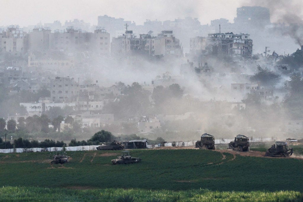 Israeli tanks and other military vehicles manoeuvre inside the Gaza Strip, as seen from Israel