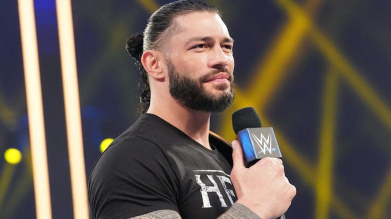 Roman Reigns holding microphone