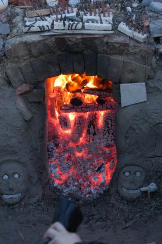 Picture of an updraft kiln during a firing.