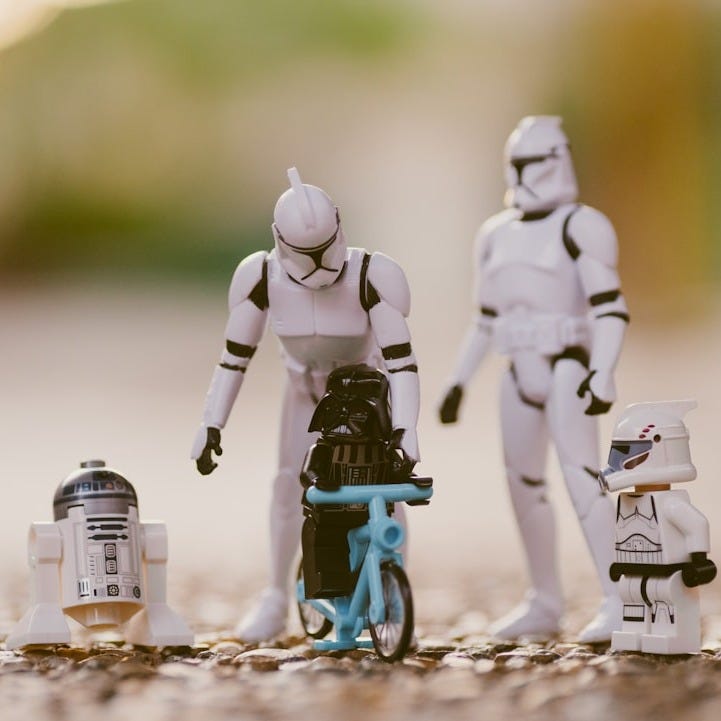 selective focus photography of Star Wars Stormtropper, R2-D2, and Darth Vader toys selective focus photography of Star Wars Stormtropper, R2-D2, and Darth Vader toys