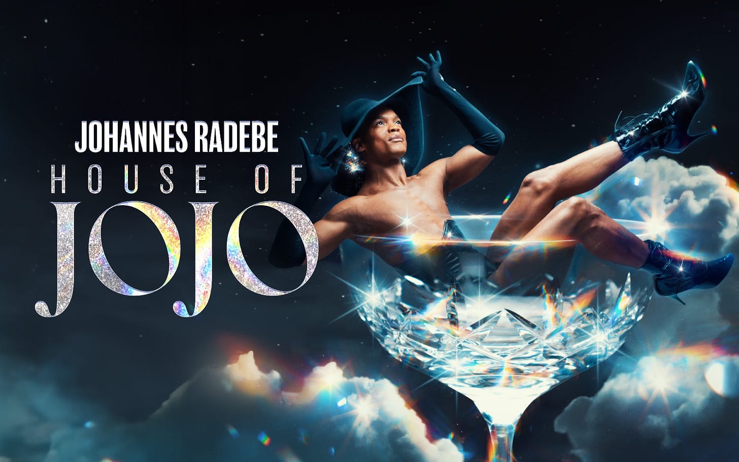 Johannes Radebe House of JoJo tour poster - a black man wearing a black floppy hat, gloves and stiletto boots sitting in a crystal glass