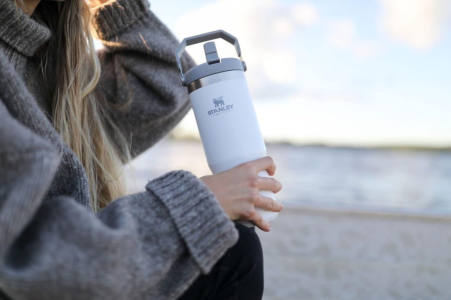 Blonde woman holding STANLEY IceFlow Stainless Steel Tumbler 