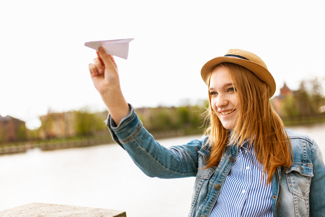 Free Girl Holding Paper Plane Stock Photo