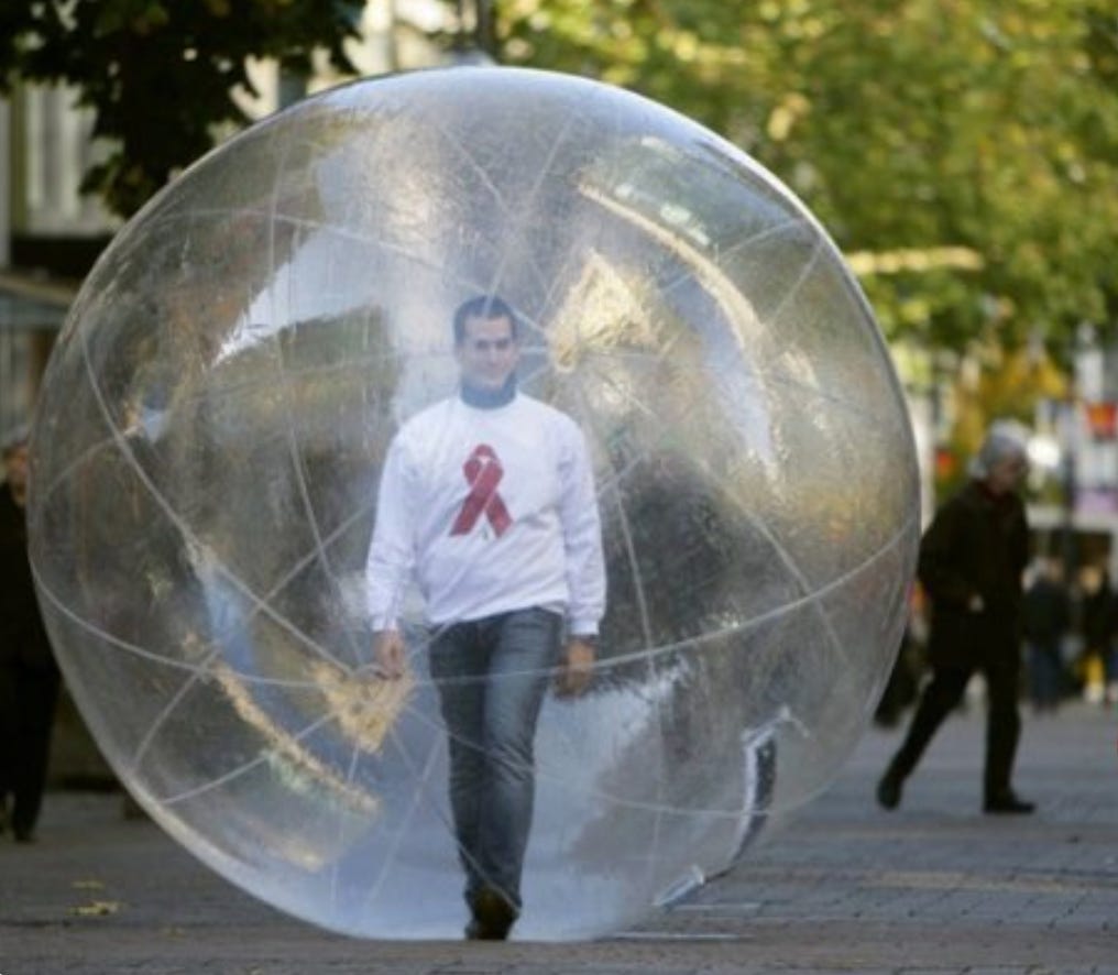 Man walking inside a giant plastic inflatable clear ball