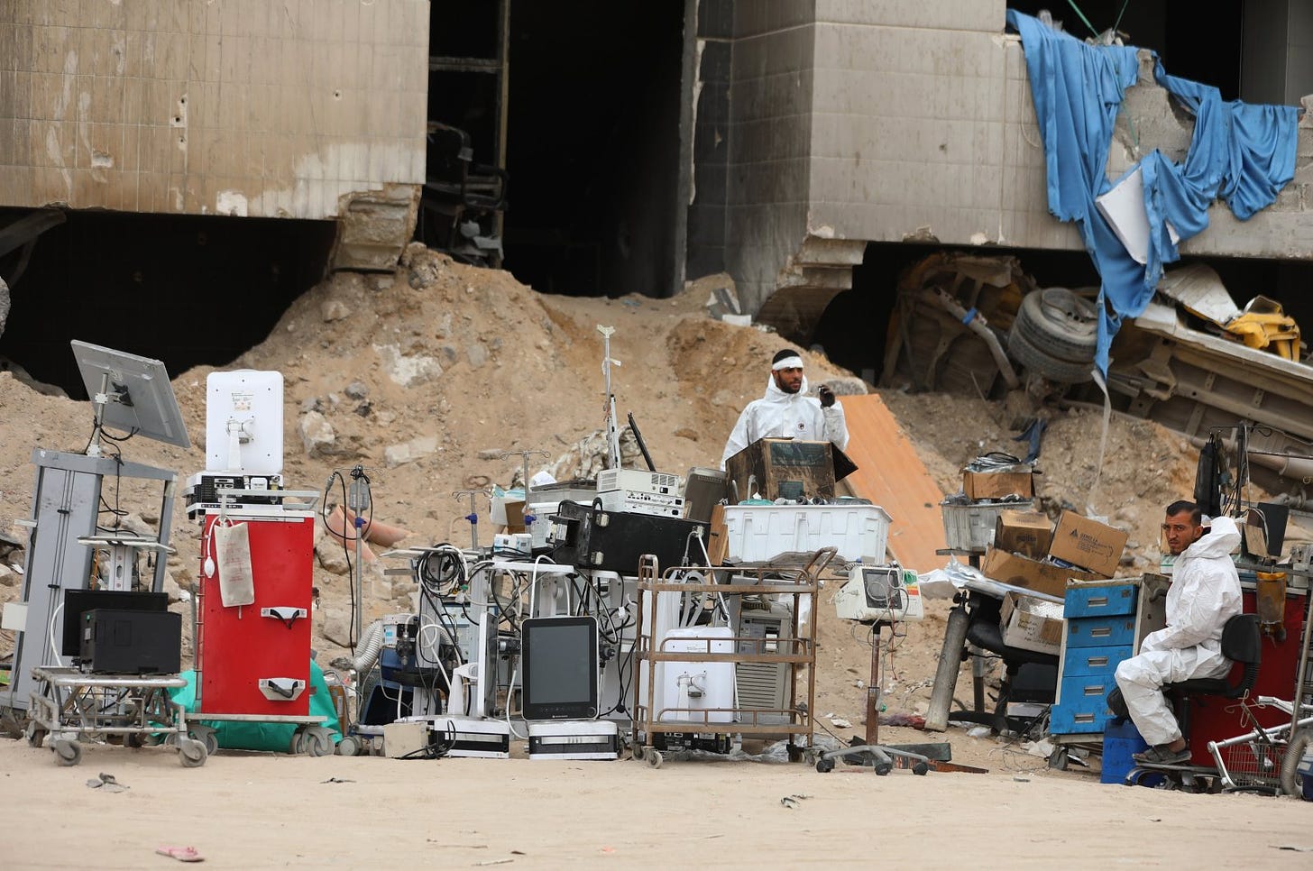 Crew members from the Palestinian ministries of health, justice, and interior stand next to medical equipment as they search among the rubble for possible bodies after the Israeli army left the Al-Shifa Medical Hospital Complex in Gaza City, April 8, 2024. (EPA Photo)