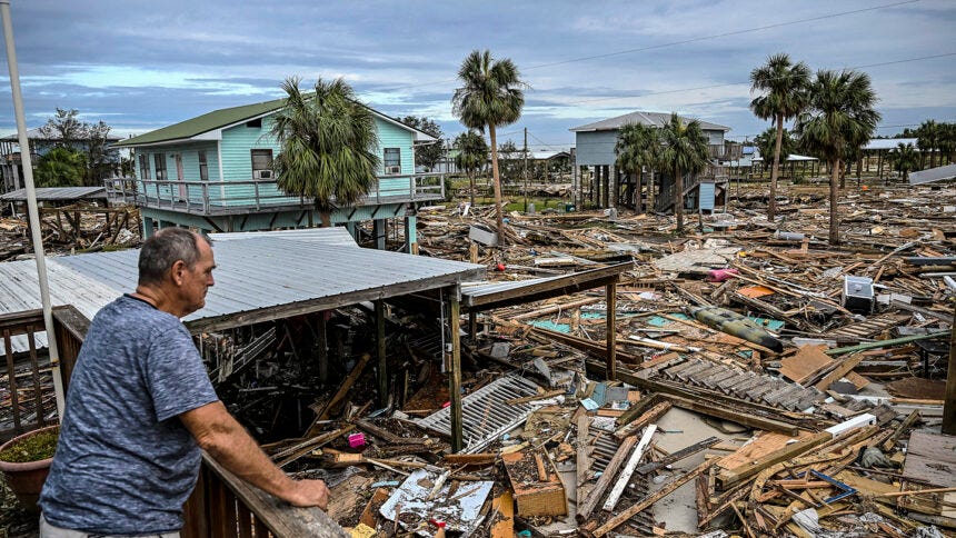 TOPSHOT - David Hester inspects damages of his house after Hurricane Helene made landfall in Horseshoe Beach, Florida, on September 28, 2024. At least 44 people died across five US states battered by powerful storm Helene, authorities said on September 27, after torrential flooding prompted emergency responders to launch massive rescue operations. (Photo by CHANDAN KHANNA / AFP)