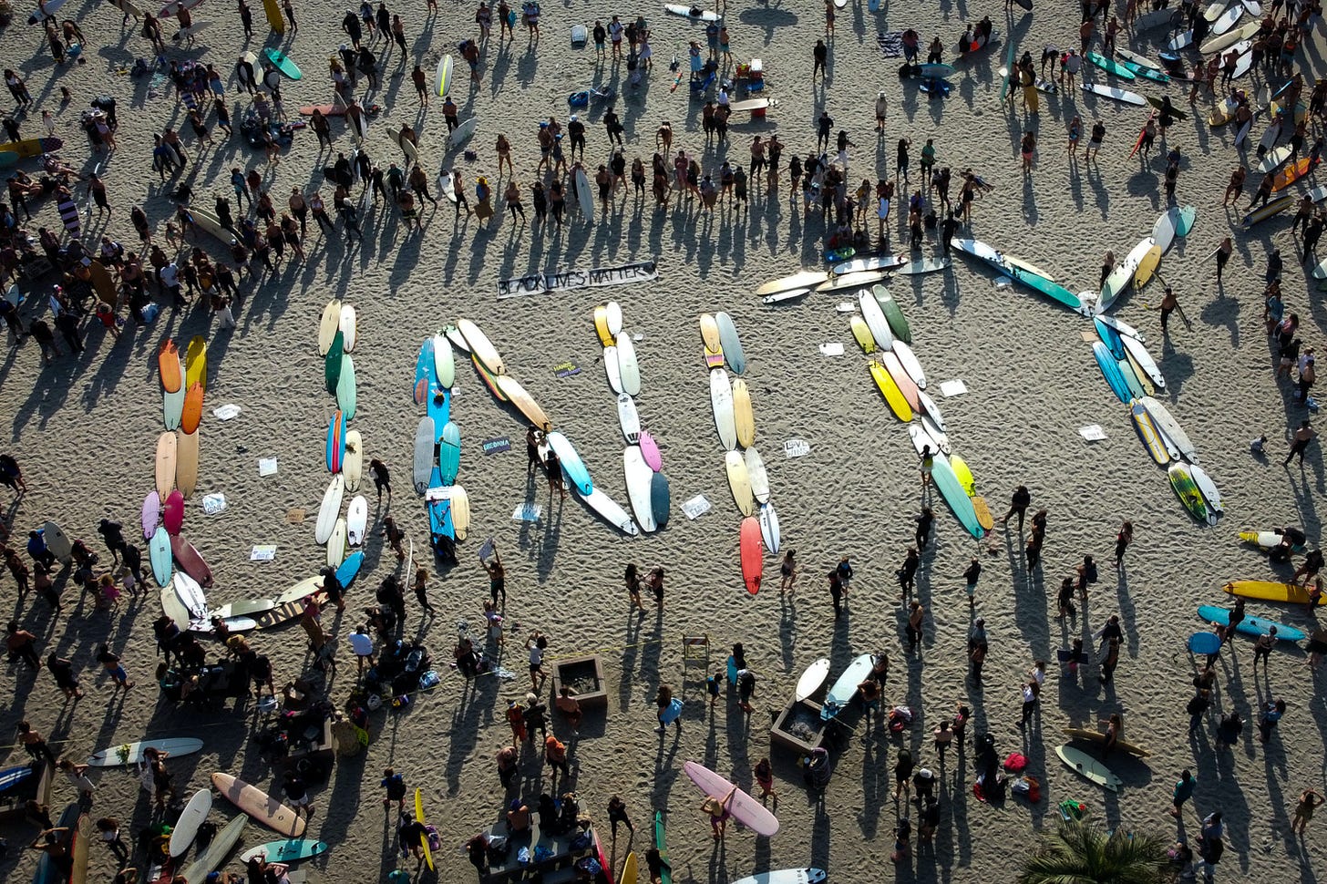 Surfboards spelling the word unity on a beach. 