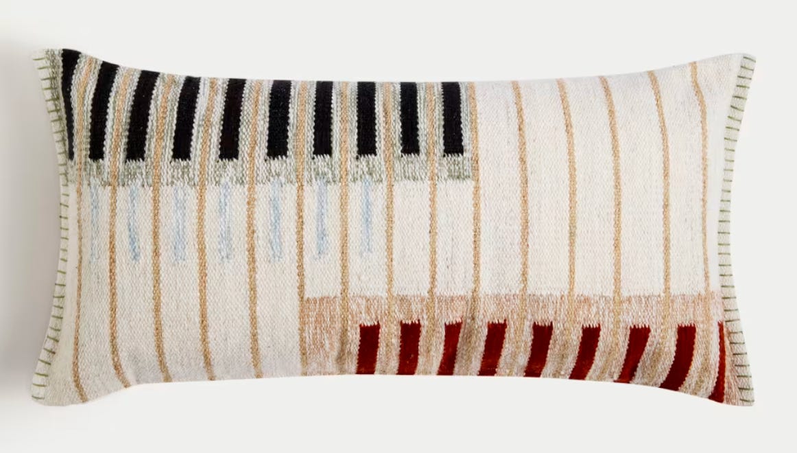 The striped design bolster cushion features bold blocks of colour woven into the fabric