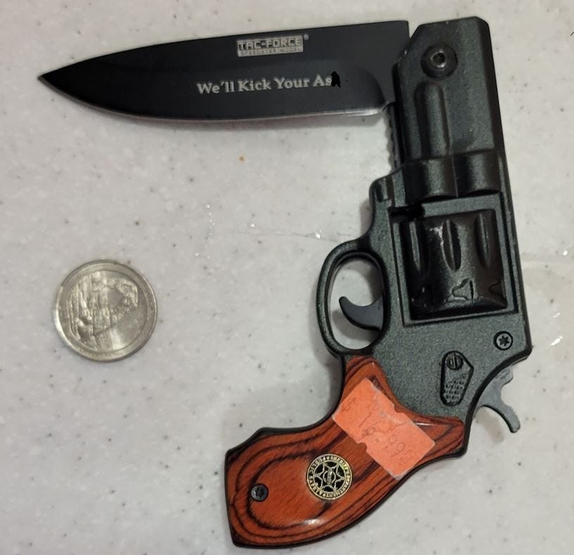 A replica handgun with a knife that unfolds and comes out of the barrel of the gun.