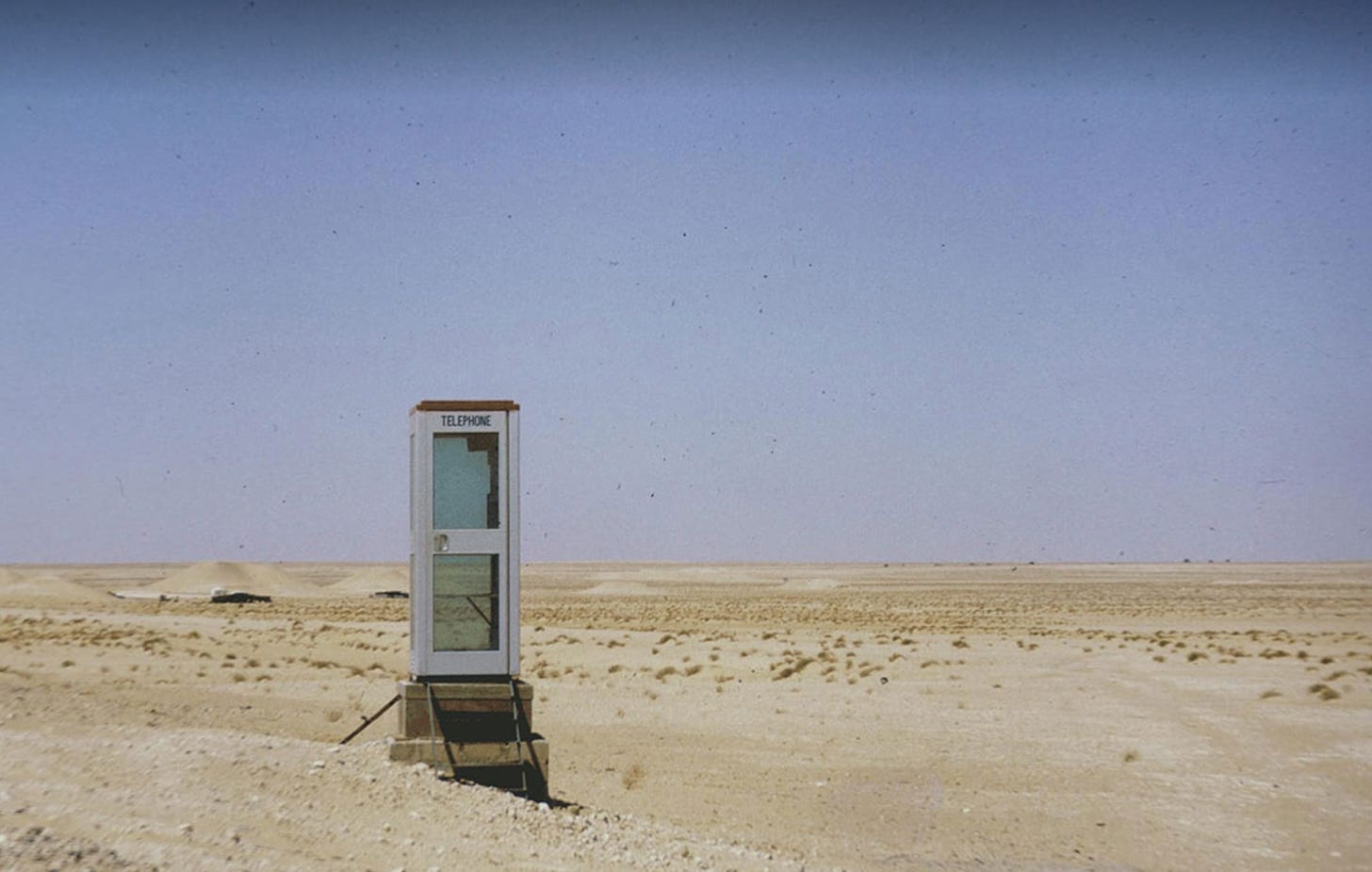 An empty phone both in the desert