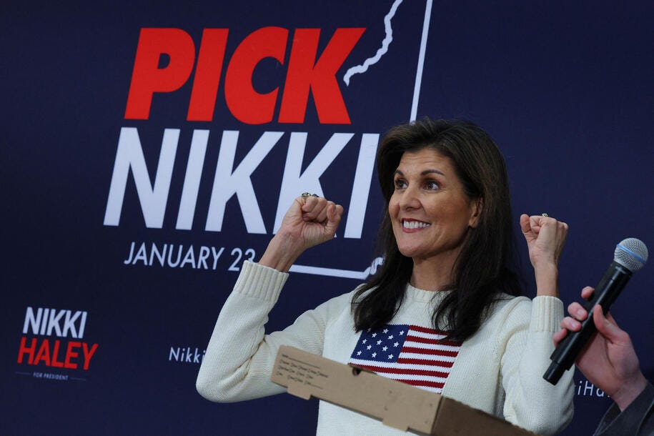 Republican presidential candidate and former U.S. Ambassador to the United Nations Nikki Haley reacts to a pizza given to her at a Get Out the Vote "Politics and Pizza" campaign stop at Franklin Pierce University ahead of the New Hampshire primary election in Rindge, New Hampshire, U.S., January 20, 2024.   REUTERS/Brian Snyder