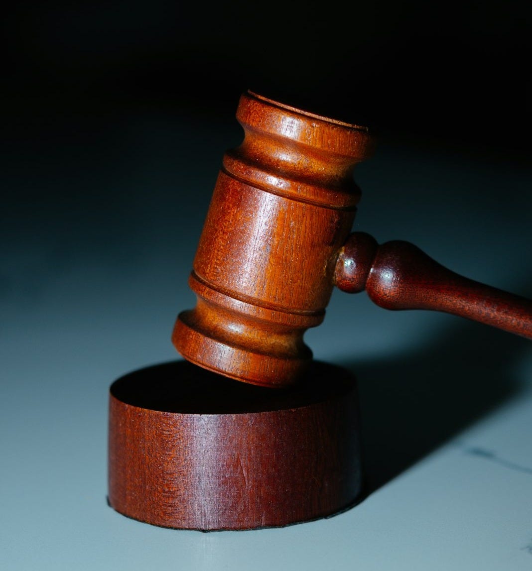 a wooden judge's hammer on top of a table