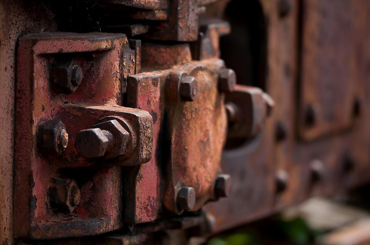 A hinge with bolts that has rusted.