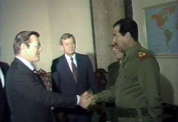 Donald Rumsfeld shakes hands with human rights abuser Saddam Hussein.