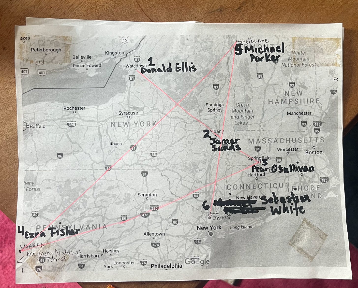 A printed out map of the Northeastern United States from Pennsylvania to Vermont. Character names from "Any Man," notes, and lines connecting various locations have been written and drawn onto the map by hand. 