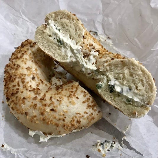 Onion bagel with spinach & artichoke cream cheese at B&D Bagel & Locks