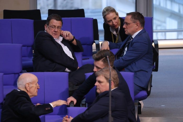 Parliamentarians of the far-right Alternative for Germany Stephan Brandner, Alice Weidel and Tino Chrupalla chat prior to a debate 