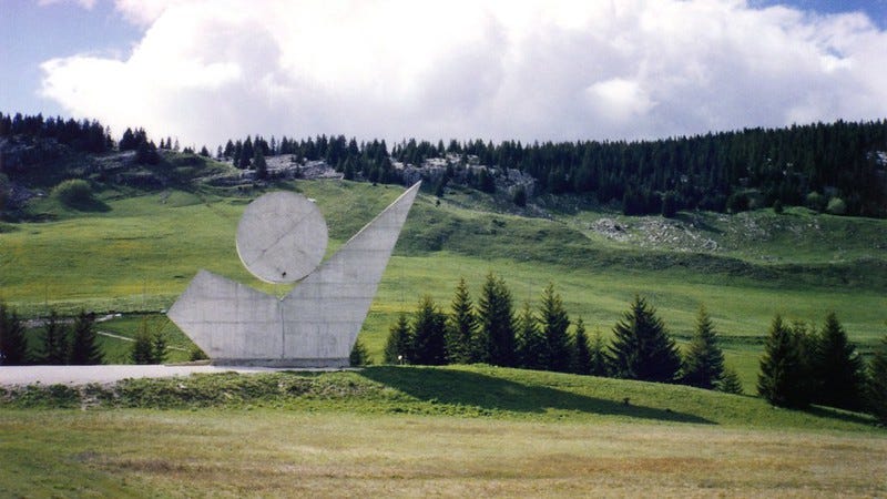 sculpture of a human pointing to the sky on an alpine plateau - author's own photo