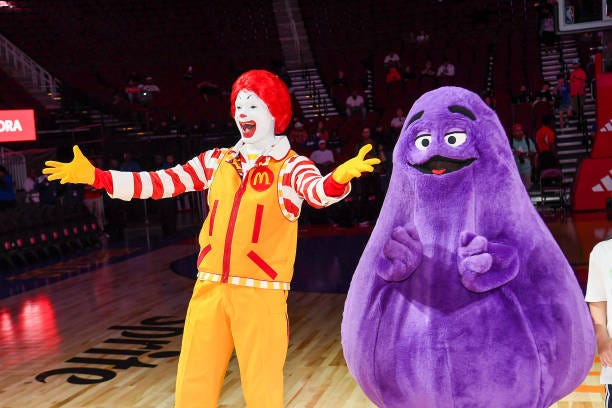 Perfromers in "Ronald McDonald" and "Grimace" costumes attend the 47th annual McDonald's All American Games at Toyota Center on April 02, 2024 in...