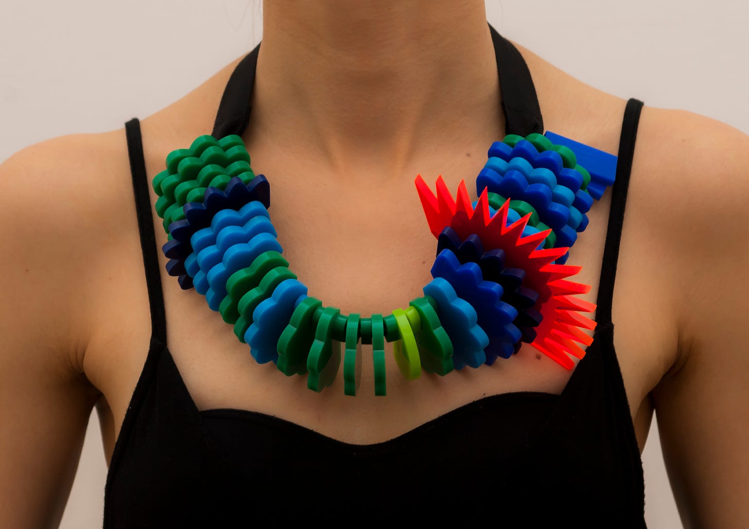 A woman wearing a colourful necklace showing PM10 data over a week