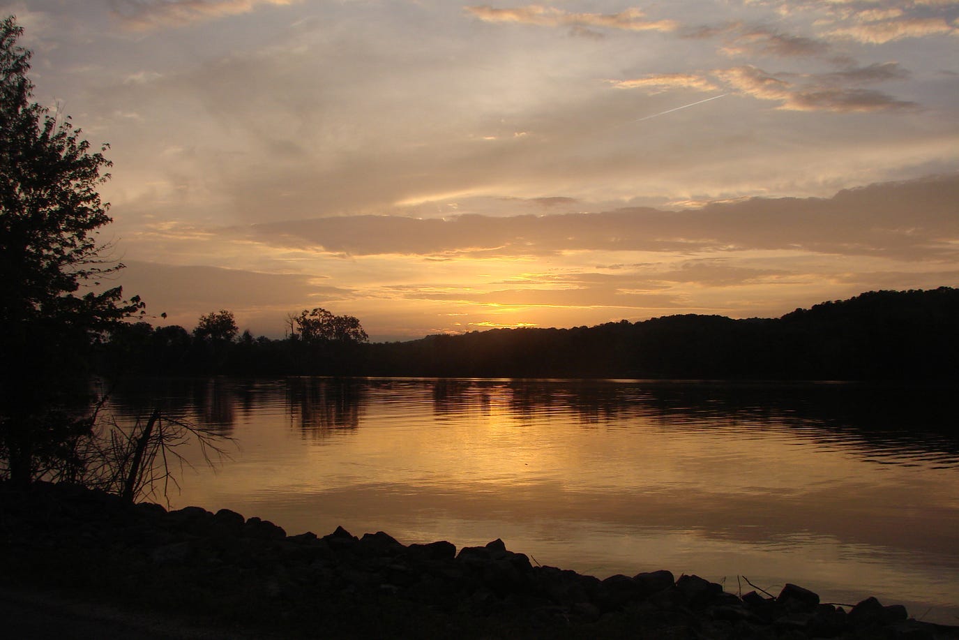 sun setting on a river. (River parable)
