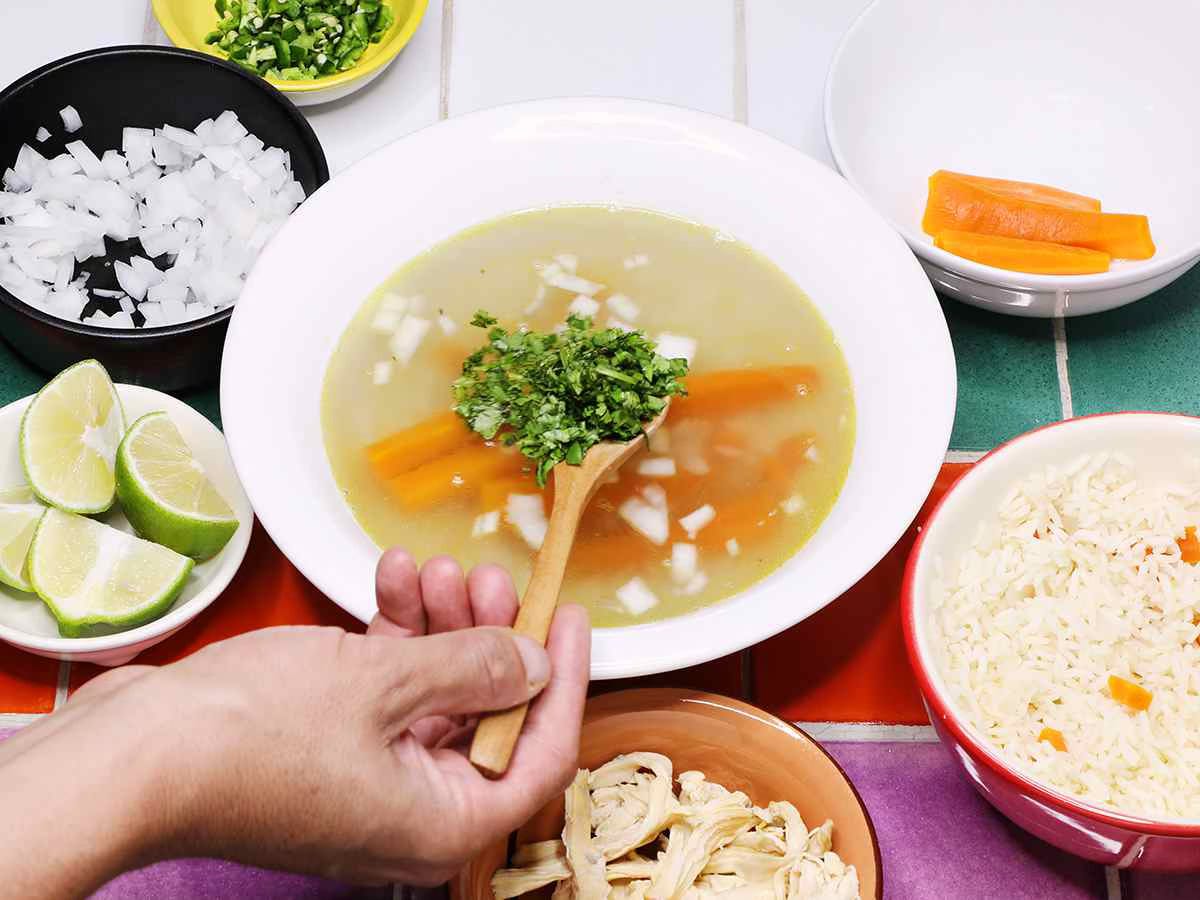 Garnishing Mexican Chicken Soup with Cilantro