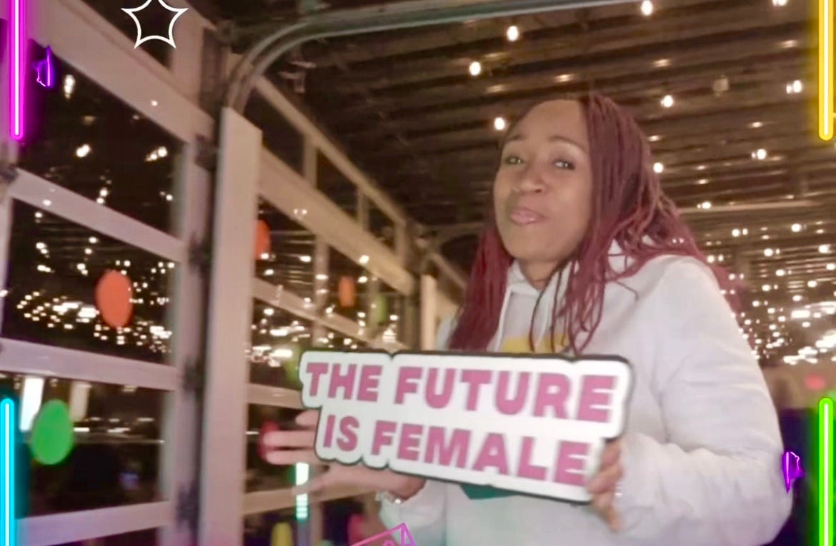 Woman holding a sign that says The Future is Female