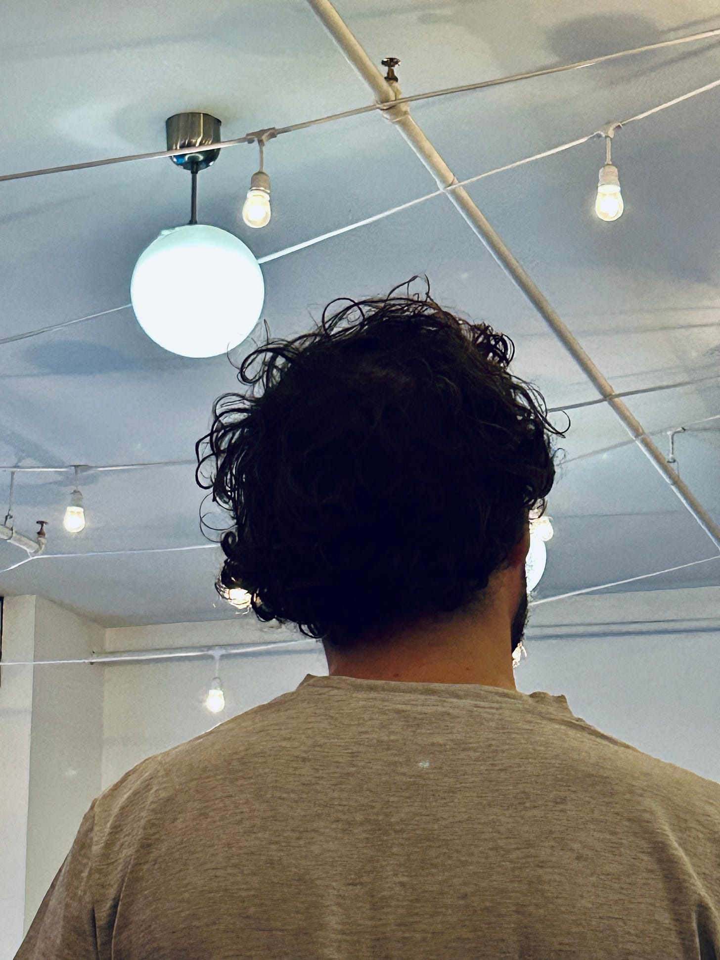 Photo of a youth with voluminous hair at a book launch.