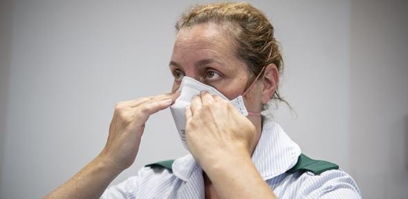 Photo of health care worker fitting a FFP3 respirator mask