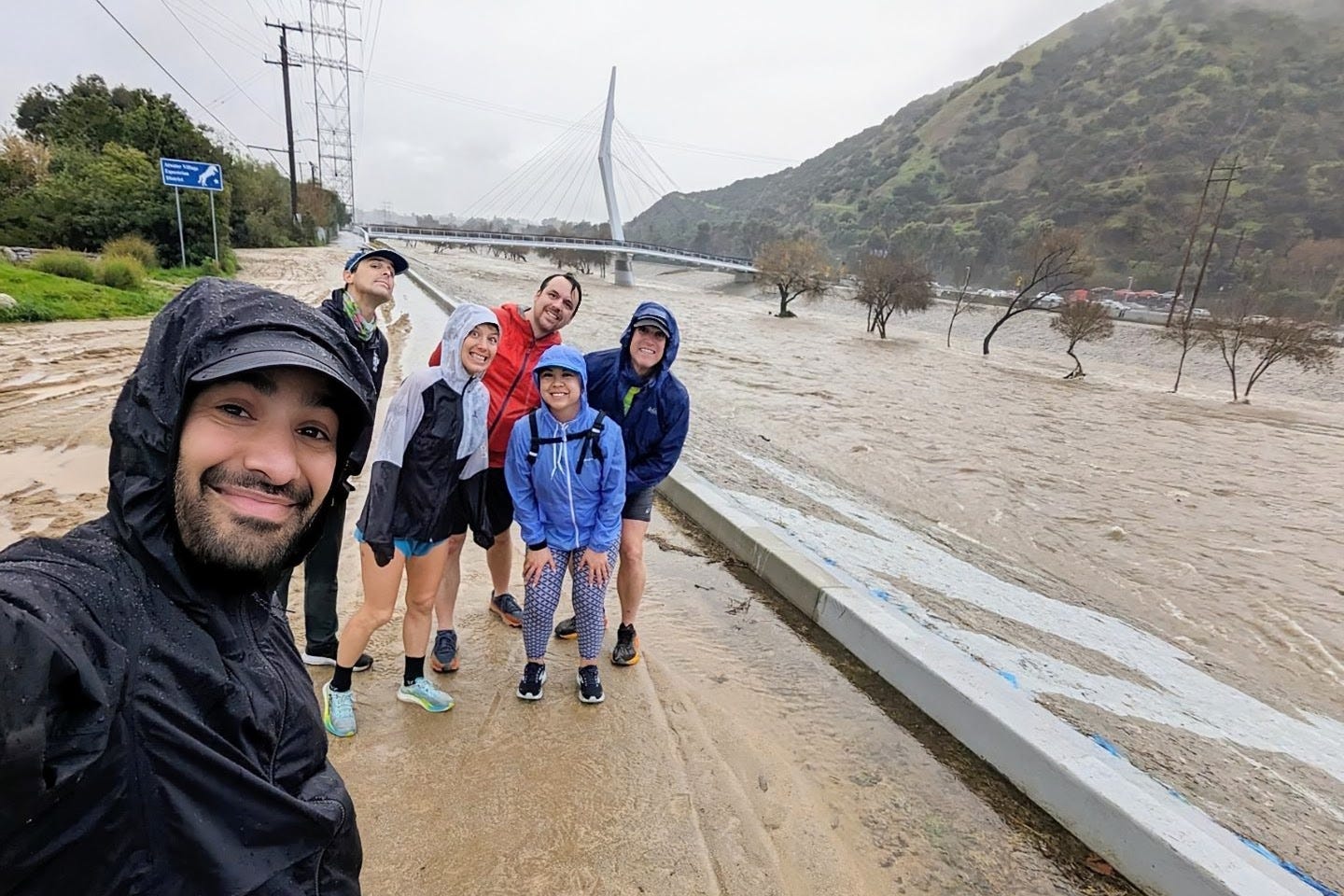 Me and the Glendale Runners posing for a wet but very safe photo on the banks of a bulging L.A. River