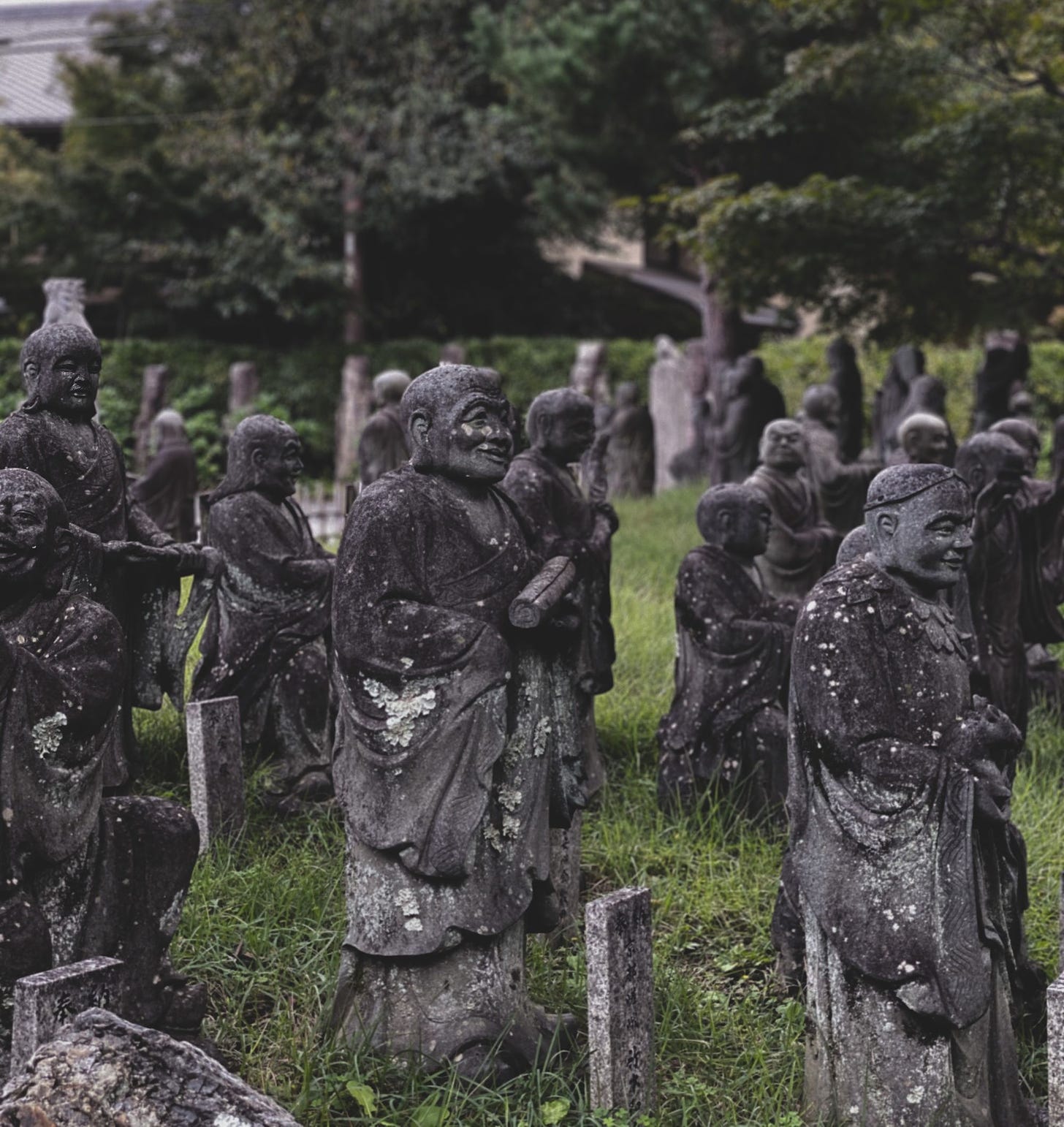 Photo of old sculptures near forest in park via Pexels