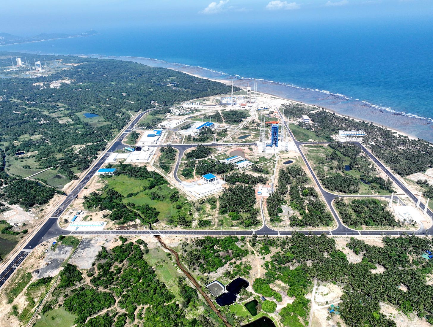 Wenchang Commercial Space Launch Site as seen from above, with the Wenchang Space Launch Site off in the top left, in early July 2024.