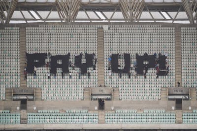 Activists climbed to the upper tier of the Baku Stadium to display their message to Cop29 negotiators. AP 