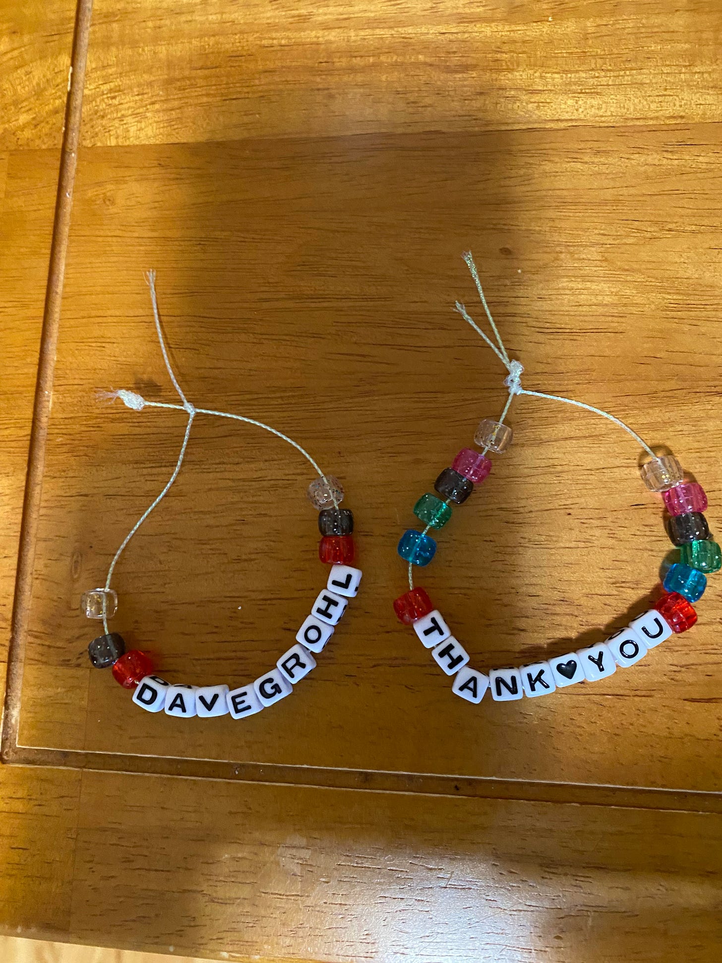Sarah's friendship bracelets that say "Dave Grohl" and "Thank you."