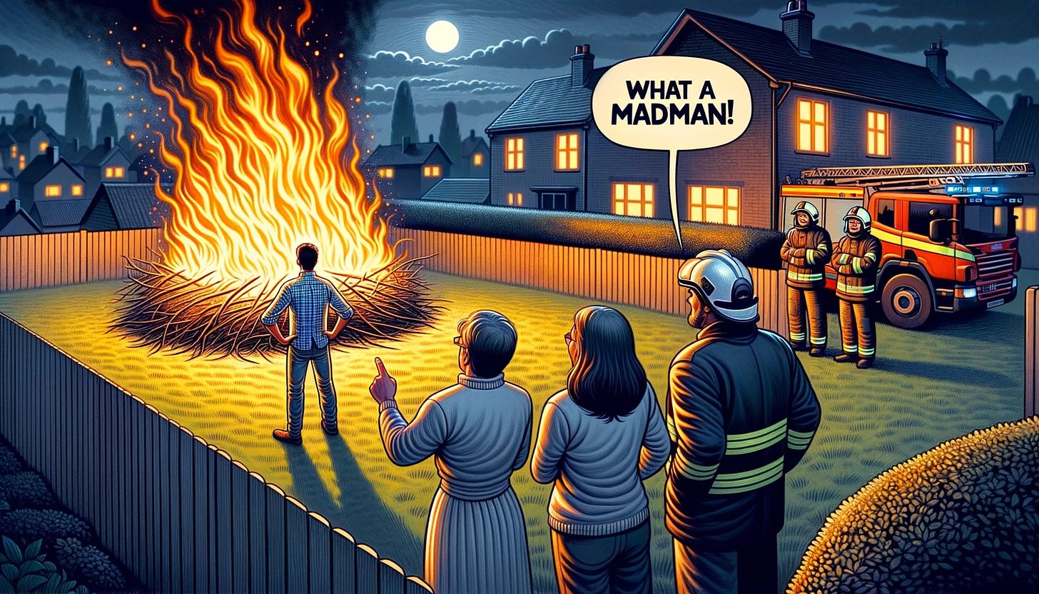 Wide cartoon portrayal where a man stands alone, captivated by a roaring bonfire in his garden. The scene is lit by the fire's blaze. On the far side, a trio of diverse neighbors, composed of an Indian man, a Caucasian woman, and an African descent man, stand with firefighters. The Indian man is pointing and exclaiming, 'What a madman!' via a speech bubble. Firefighters look concerned, discussing their next steps.
