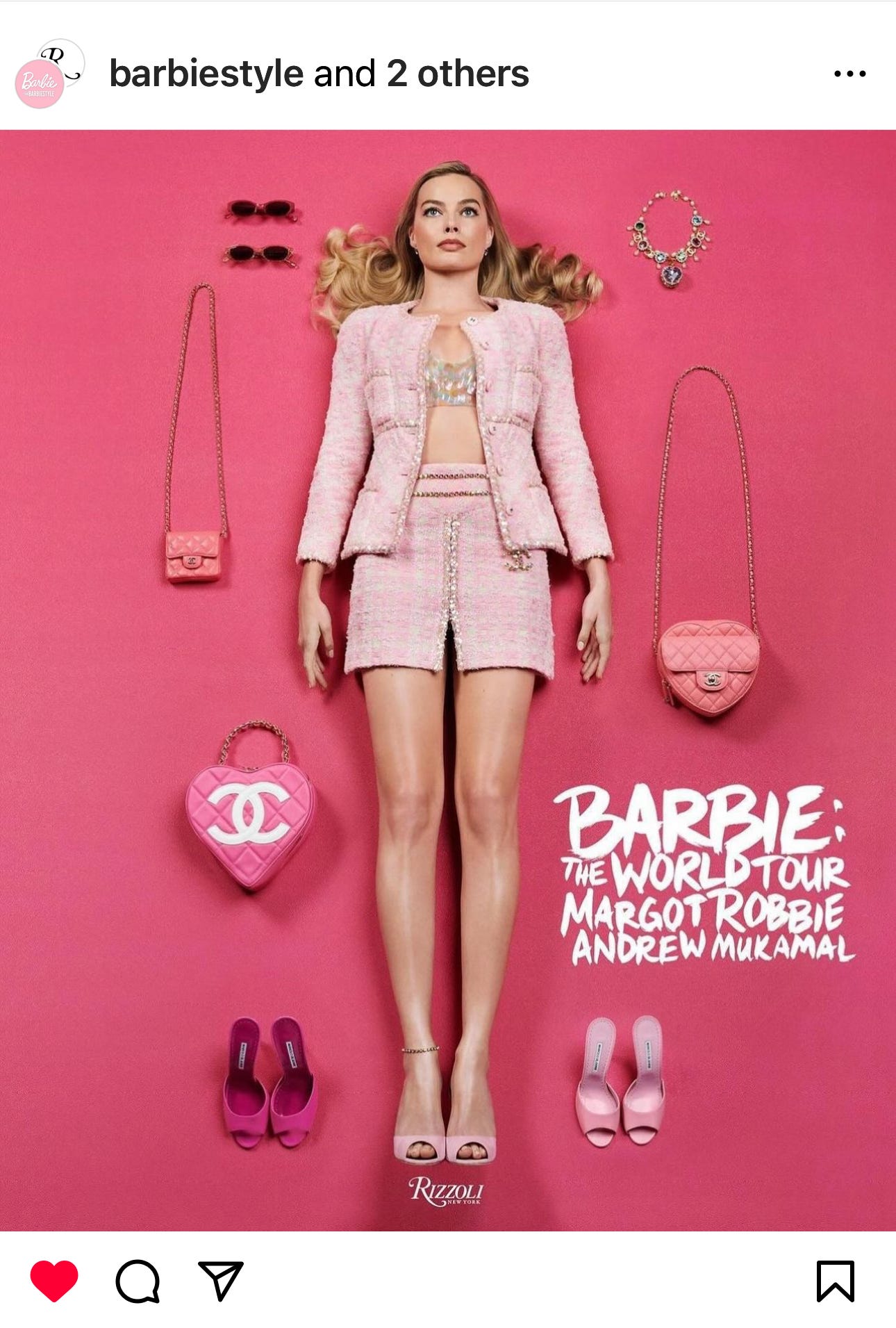 Book cover with an image of Margot Robbie against a pink backdrop with pink accessories. Text on image reads: Barbie the World Tour Margot Robbie Andrew Mukamal. Caption reads: Barbie: The World Tour hits shelves this March. From red carpet moments to never-before-seen looks, Margot Robbie and stylist @AndrewMukamal curate the ultimate fashion homage to Barbie. This unique book is a treasure trove of rare materials from @Mattel’s archives, with contributions from Margot, Andrew, and the world-famous designers they worked with to recreate iconic Barbie looks – all shot by @craigmcdeanstudio. Pre-order a copy from your favorite bookseller or visit @rizzolibooks to learn more. #barbie #barbiestyle