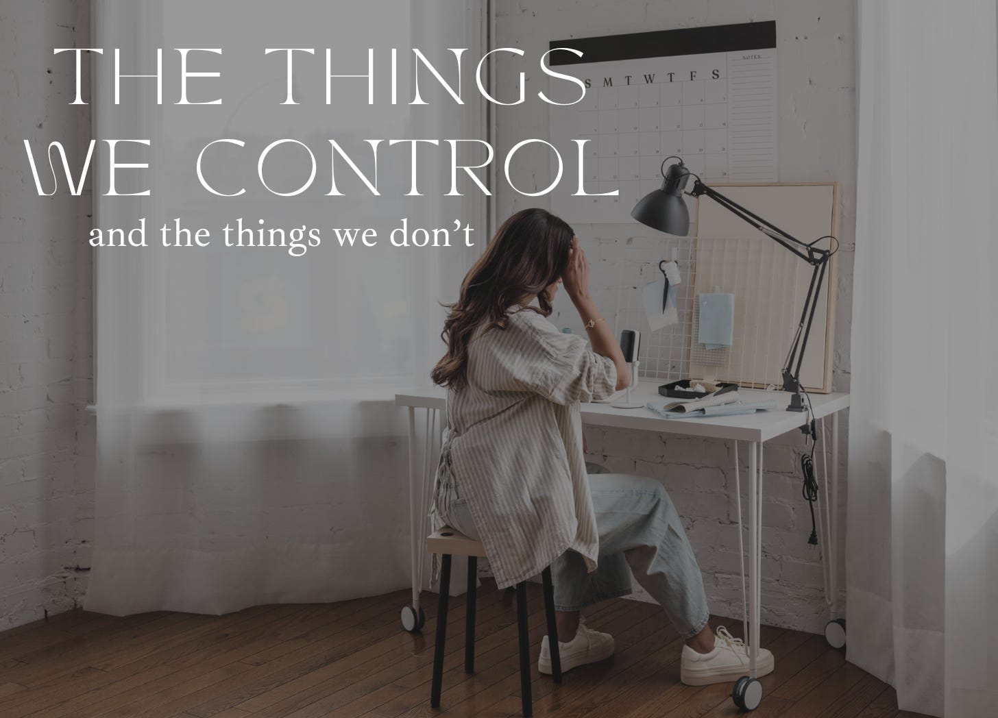 A woman sits at a small desk between two windows with a calendar. She wears jeans and a casual top. Text: The things we control, and the things we don't