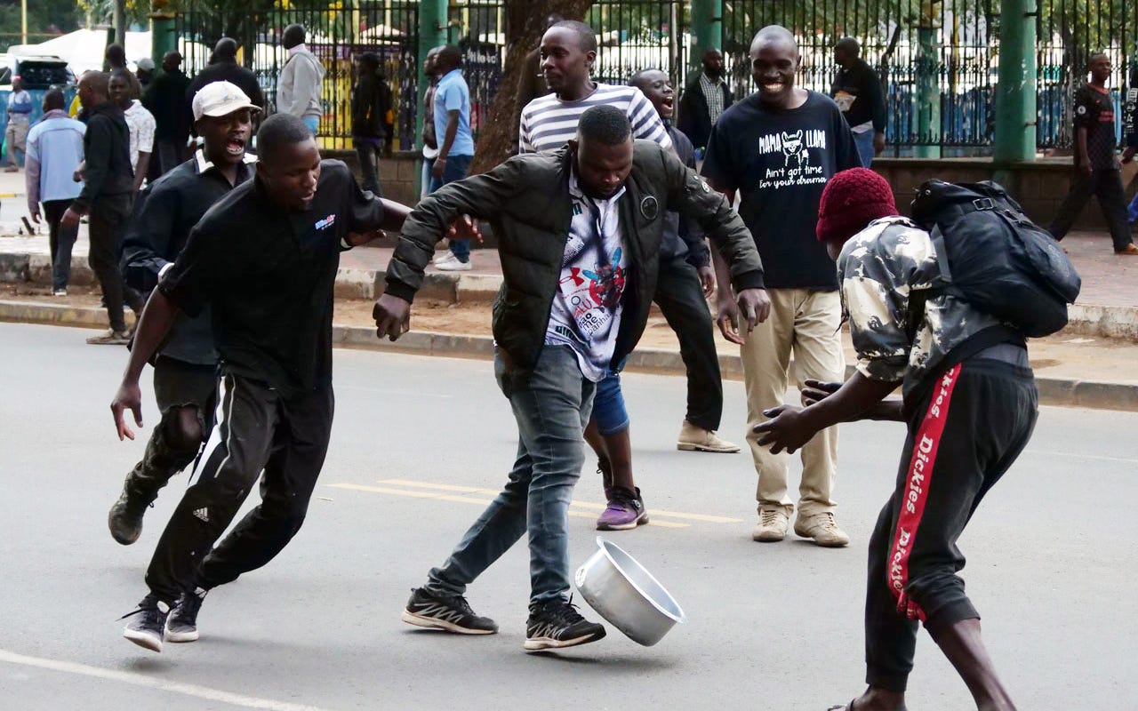 Protestors kicking around a sufuria (aluminum cooking pot) during the Azimio protests on March 20