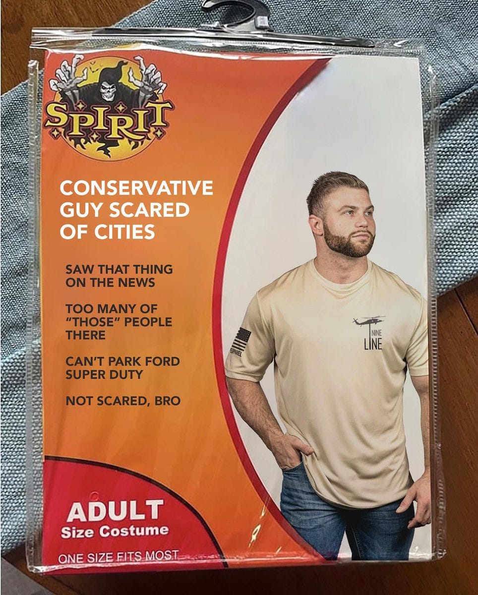 Spirit Halloween costume of guy wearing basic t-shirt titled "Conservative Guy Scared of Cities" and listing all the stupid fake reasons MAGAs hate cities